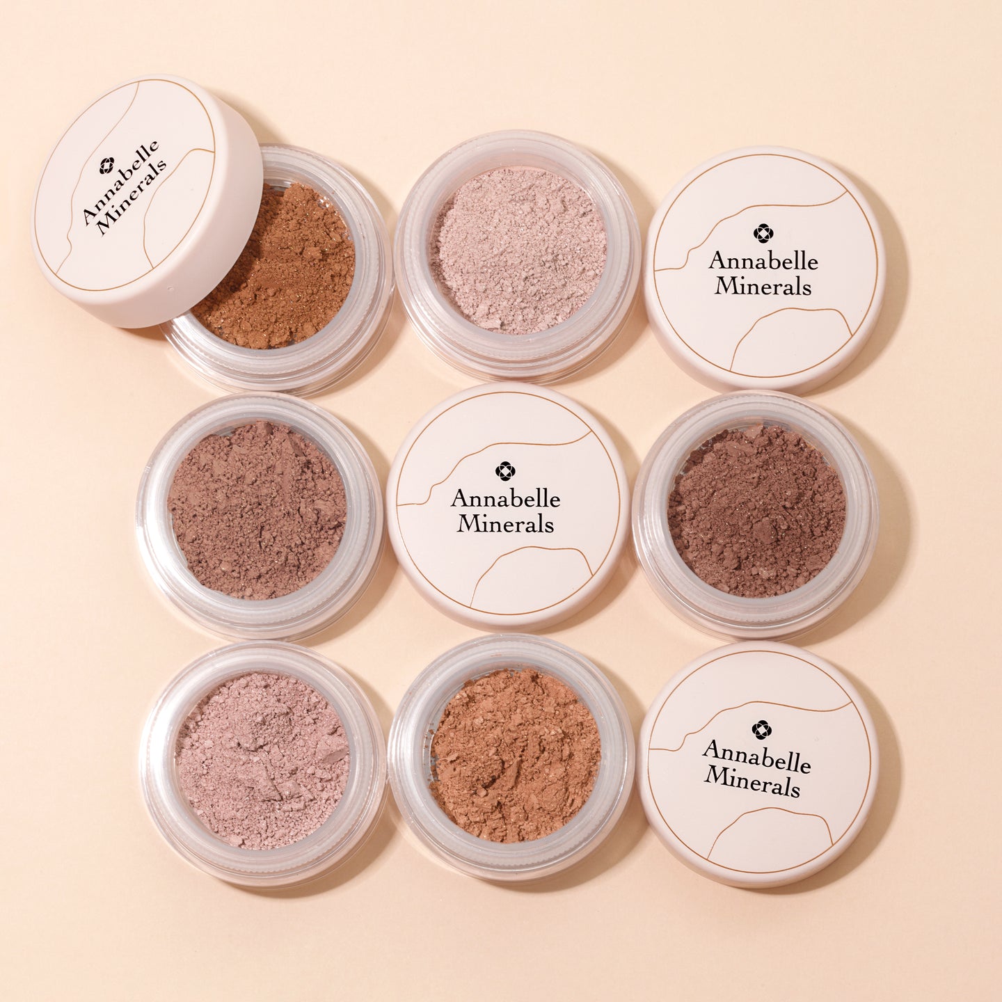 Osiem pojemników cieni mineralnych Annabelle Minerals w różnych odcieniach brązu
