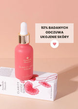 Różowa buteleczka serum Clarity Juice Annabelle Minerals z pipetą na białym pudełku, wskazująca na łagodzący działanie produktu do pielęgnacji skóry