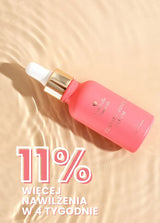 Różowa butelka serum Clarity Juice Annabelle Minerals do pielęgnacji skóry z pipetą na falującym, wodnym tle